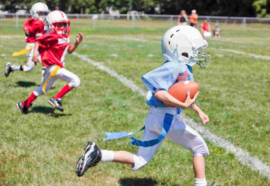 Unidentifiable kids playing flag American football